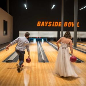 Bride and groom bowling